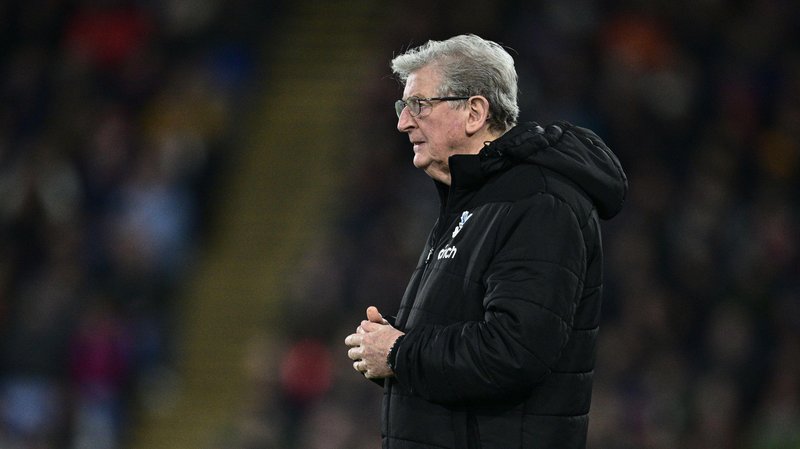 Roy Hodgson is wearing a long black jacket as he watches a game while manager of Crystal Palace in 2024.