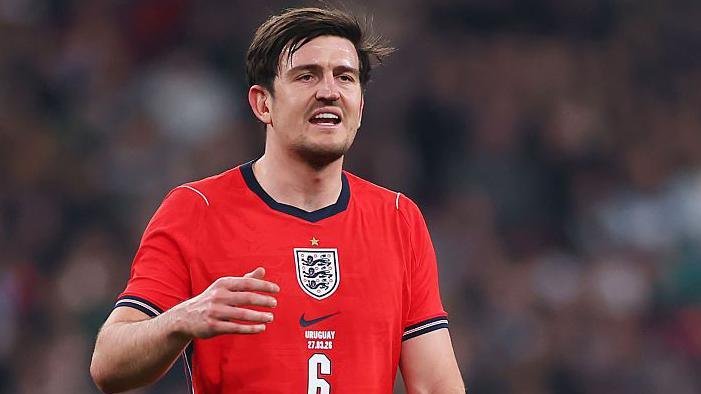 Harry Maguire in England's red shirt which includes the Three Lions badge, the number 6 and the lettering URUGUAY 27.03.26