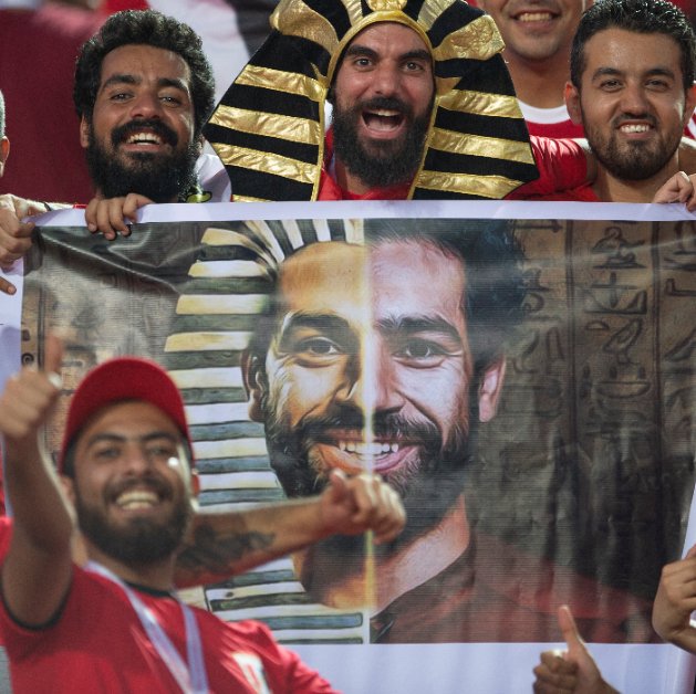 Egypt fans at the 2019 Africa Cup of Nations hold up a banner showing the face of forward Mohamed Salah