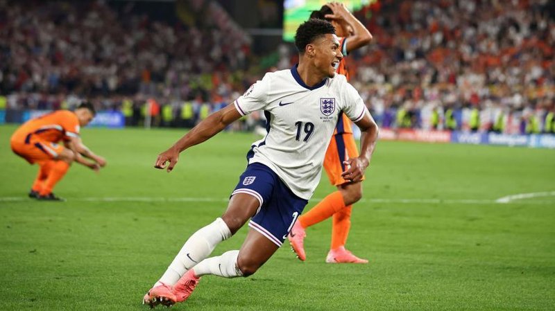 Ollie Watkins celebrates in an England shirt