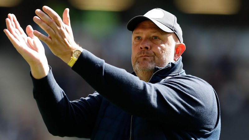Bromley boss Andy Woodman applauds the fans after their loss at MK Dons.