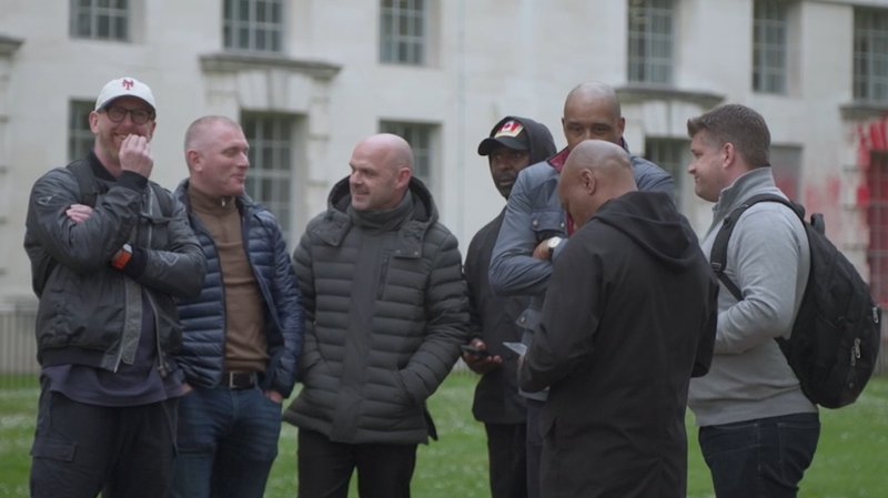 Footballers, including Tommy Johnson, Danny Murphy, Andy Cole and Brian Deane, stand together talking in Westminster. 