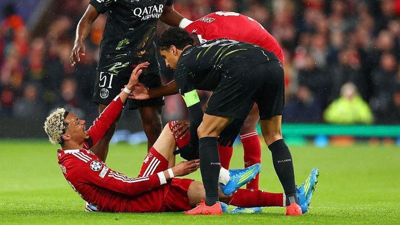 Ekitike lies on the turf in pain as concerned players from both Liverpool and Paris St-Germain tend to him