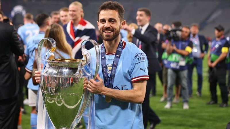 Bernardo Silva holds the Champions League trophy
