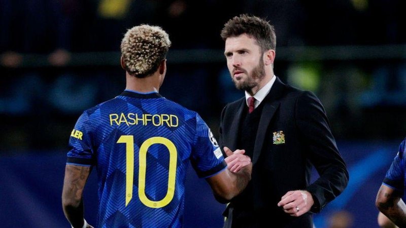 Michael Carrick greets Marcus Rashford