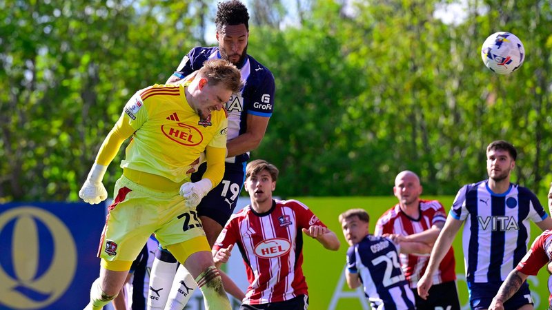Goalkeeper Jack Bycroft rises to head home the equaliser for Exeter City