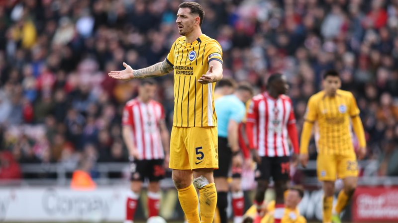 Lewis Dunk holds his arms out