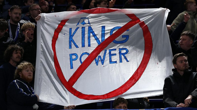 A sign is held by some Leicester City fans in protest of the club's ownership