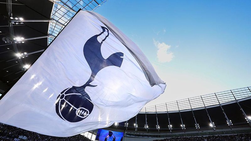 A white flag with a Tottenham Hotspur crest on it