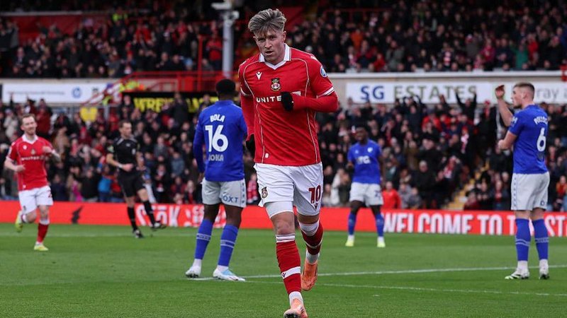 Josh Windass celebrates after scoring for Wrexham