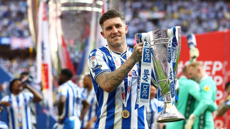Josh Windass with the League One play-off trophy after promotion with Sheffield Wednesday