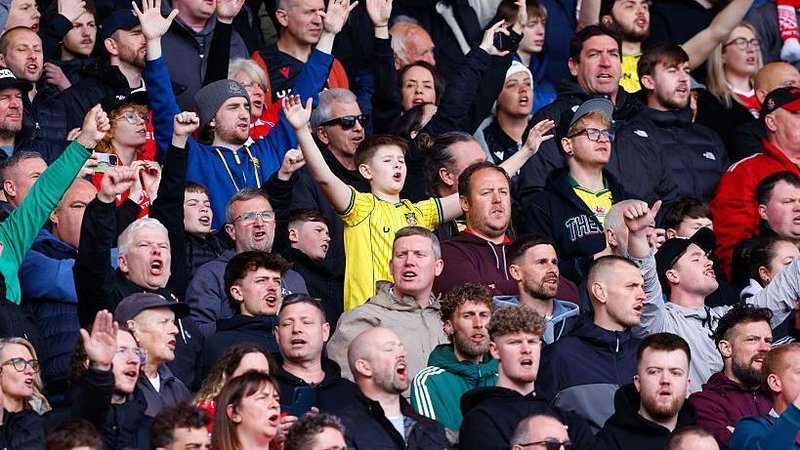 Fans sing as they watch Wrexham AFC