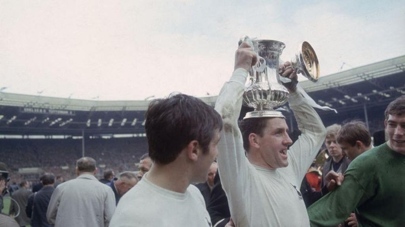 Tottenham captain Dave Mackay holds the FA Cup on his head as he celebrates Spurs' 2-1 win over Chelsea in the 1967 final at Wembley
