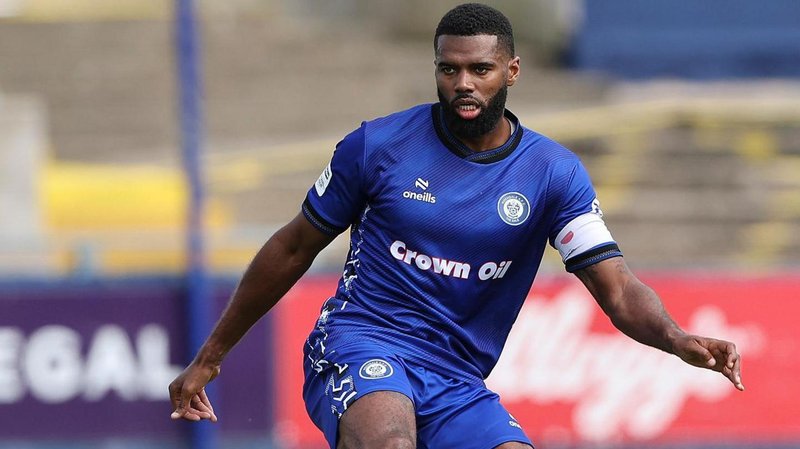 Rochdale captain Ethan Ebanks-Landell in action in his side's blue home kit