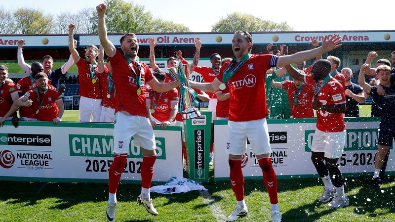York City players celebrate with the National League trophy