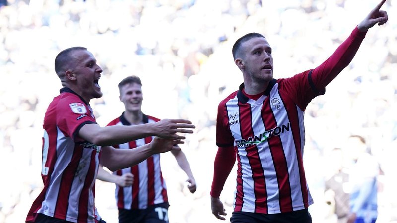 Jack Moylan (right) celebrates scoring for Lincoln in their promotion-clinching game against Reading