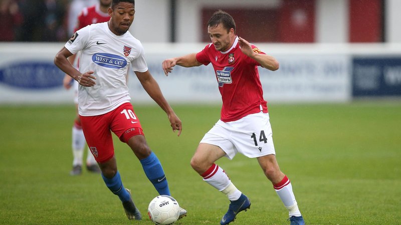 Paul Rutherford of Wrexham takes on Angelo Balanta of Dagenham and Redbridge during Dagenham & Redbridge vs Wrexham in 2019