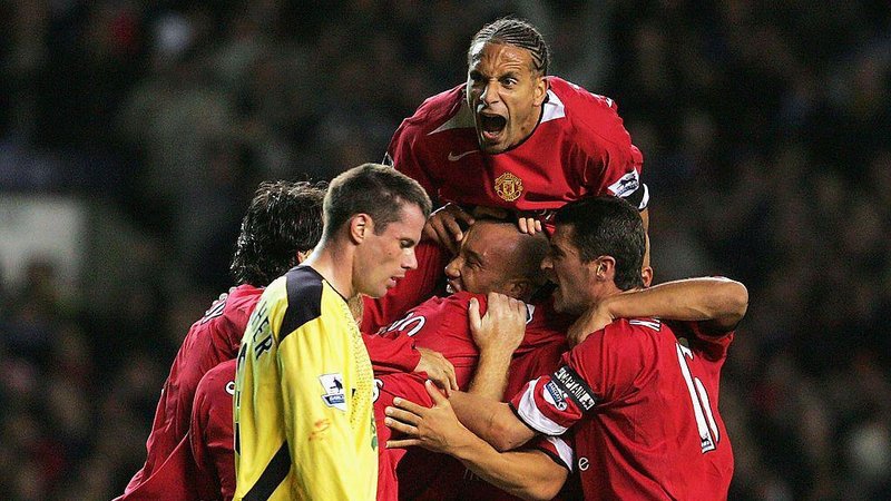 Manchester United players celebrate next to Jamie Carragher
