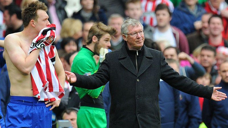 Phil Jones and Sir Alex Ferguson look on in despair