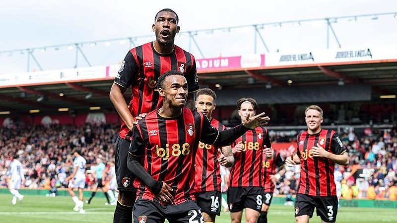 Rayan jumps on Junior Kroupi's back after his goal against Crystal Palace