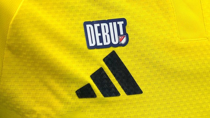 An MLS debut patch on the yellow jersey of a Columbus Crew player