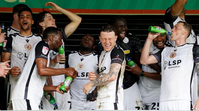 Bromley players celebrate after the final game of the season