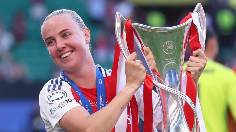 Arsenal forward Beth Mead holding the Women's Champions League trophy