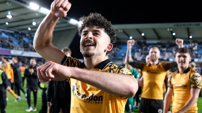 Hull City winger Mohamed Belloumi celebrates in front of his team-mates after their 2-0 win at Millwall