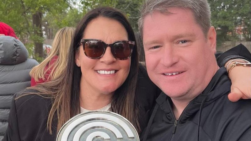 Liverpool Women manager Matt Beard and his wife Debbie smile while celebrating the Reds' Championship title win