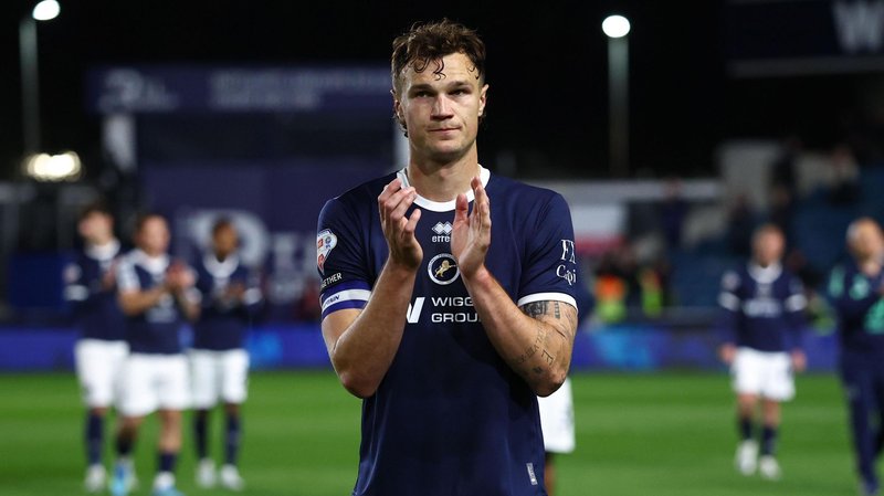 Millwall captain Jake Cooper applauds the fans, looking dejected after they were beaten by Hull City