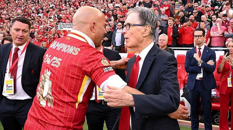 Liverpool's principle owner John W. Henry congratulates Arne Slot after last season's title win.
