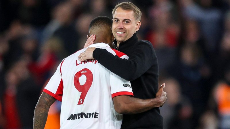 Tonda Eckert has a big smile on his face as he hugs Cyle Larin (LARIN 9) at the end of the match 