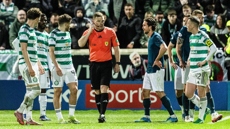 Referee John Beaton is surrounded by Celtic players