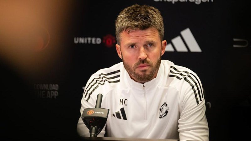 Michael Carrick speaking in a pre-match news conference. 