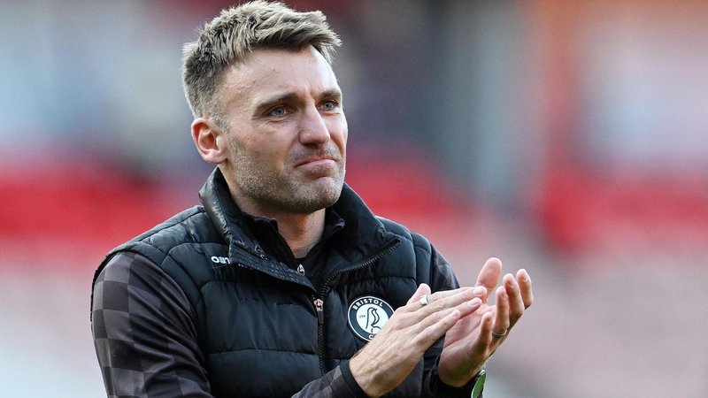 Chris Manning applauds fans during his time as Bristol City assistant head coach