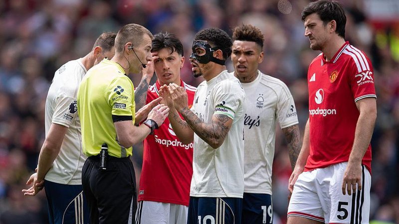 Nottingham Forest captain Morgan Gibbs-White talks with referee Michael Salisbury after he decides to allow a Manchester United goal despite VAR intervention