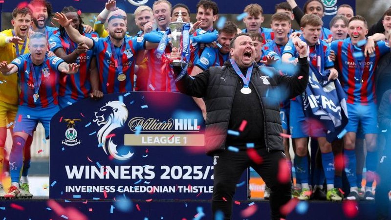Inverness Caledonian Thistle head coach Scott Kellacher, dressed in black, joins the rest of the team celebrate the League One win