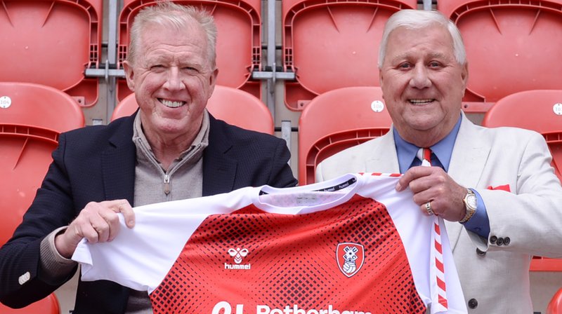 Steve McClaren is holding a red Rotherham United shirt alongside Tony Stewart.