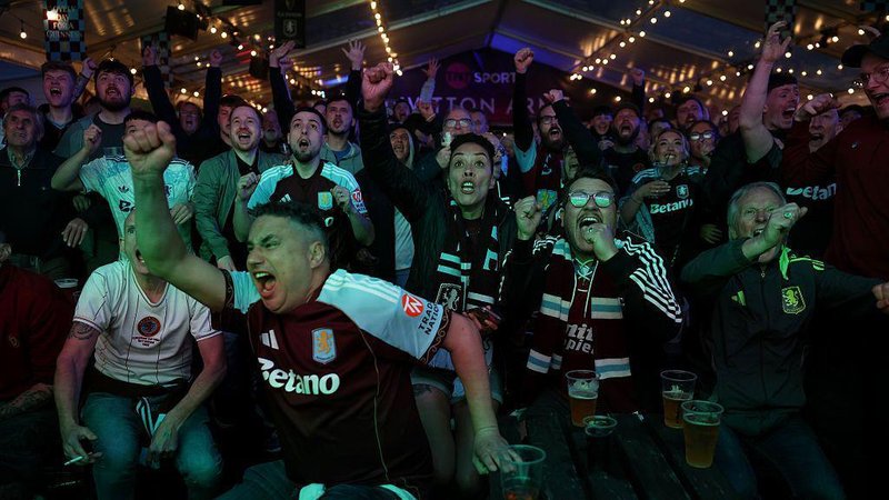 Aston Villa fans celebrate in a pub