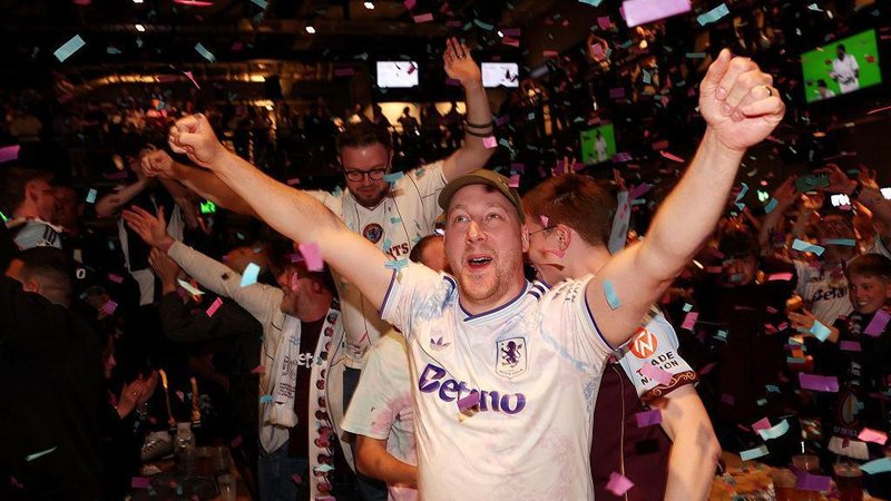 Aston Villa fans with confetti in a pub