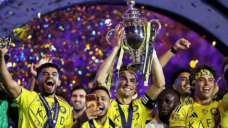 Cristiano Ronaldo of Al-Nassr lifts the Saudi Pro League trophy as he stands with team-mates following the match against Damac