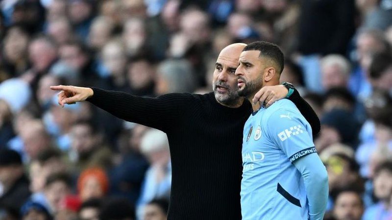 Kyle Walker gets tactical instructions from Pep Guardiola during a Premie League game in October 2024
