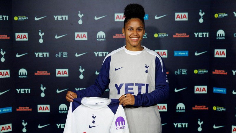 Martinez holding Spurs shirt 